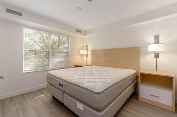 Large bedroom with a large bed and a wooden nightstand